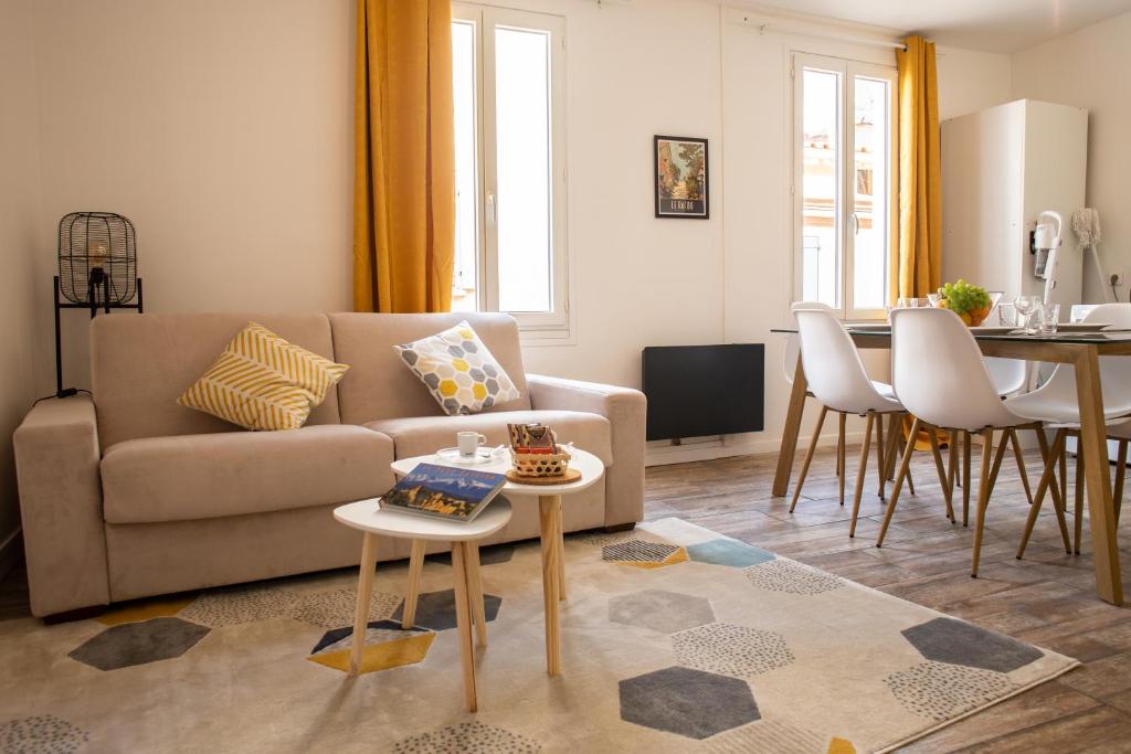 a living room with a couch and a table at Au coeur de Perpignan in Perpignan