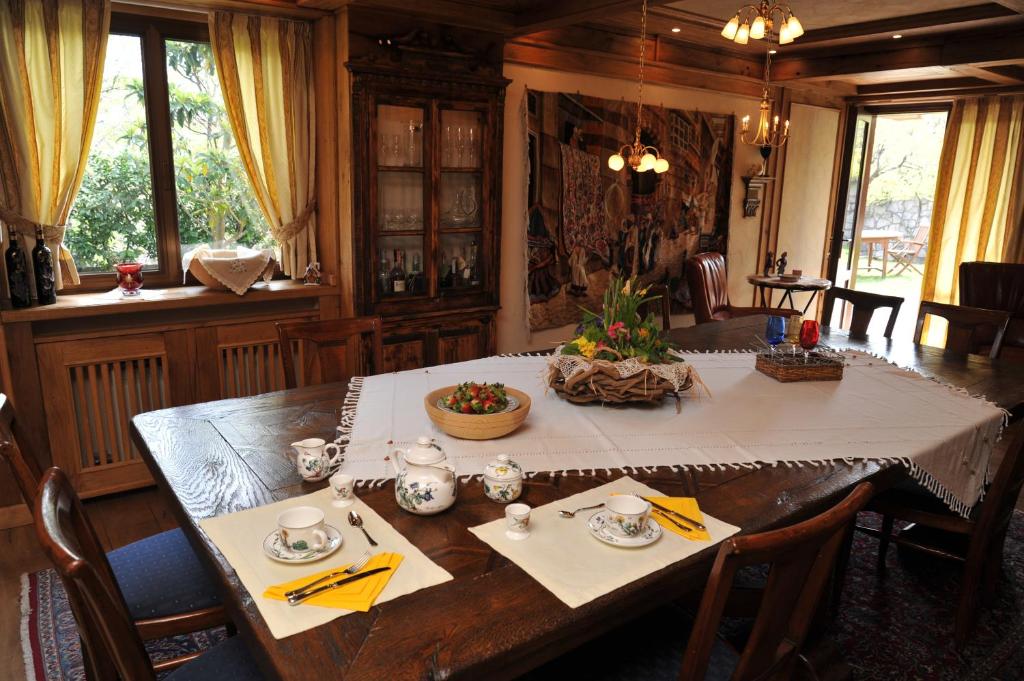 a dining room with a table with a white table cloth at Bonavia B&B in Sistiana