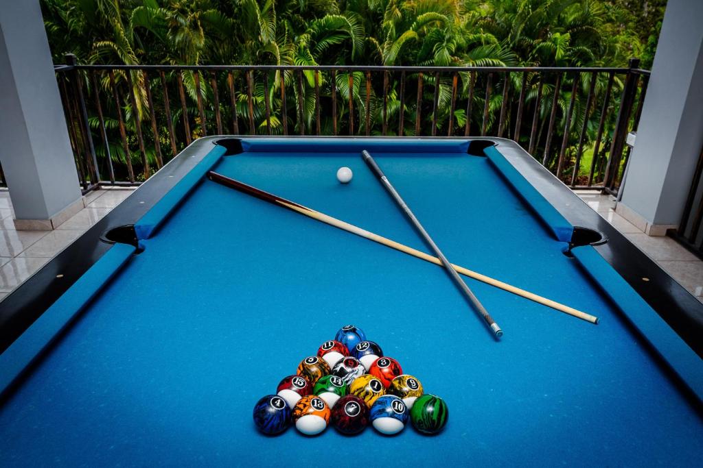 a pool table with balls and cue sticks on it at Green Studio 1 - just 7 min drive to the beach in Rincon