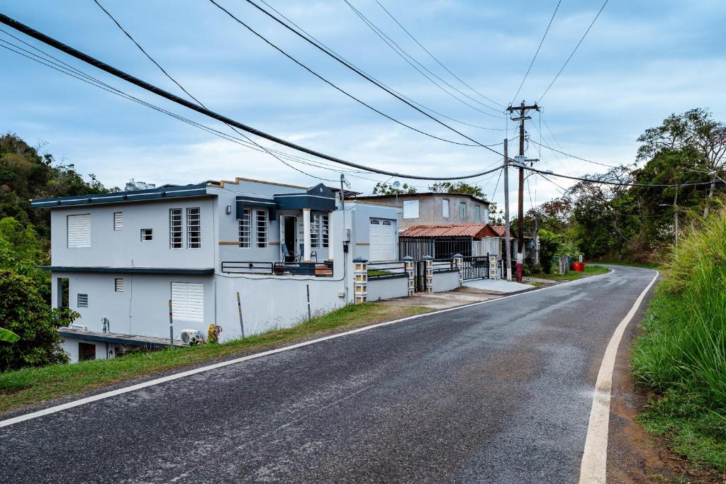 a house on the side of a road at Green Studio 1 - just 7 min drive to the beach in Rincon