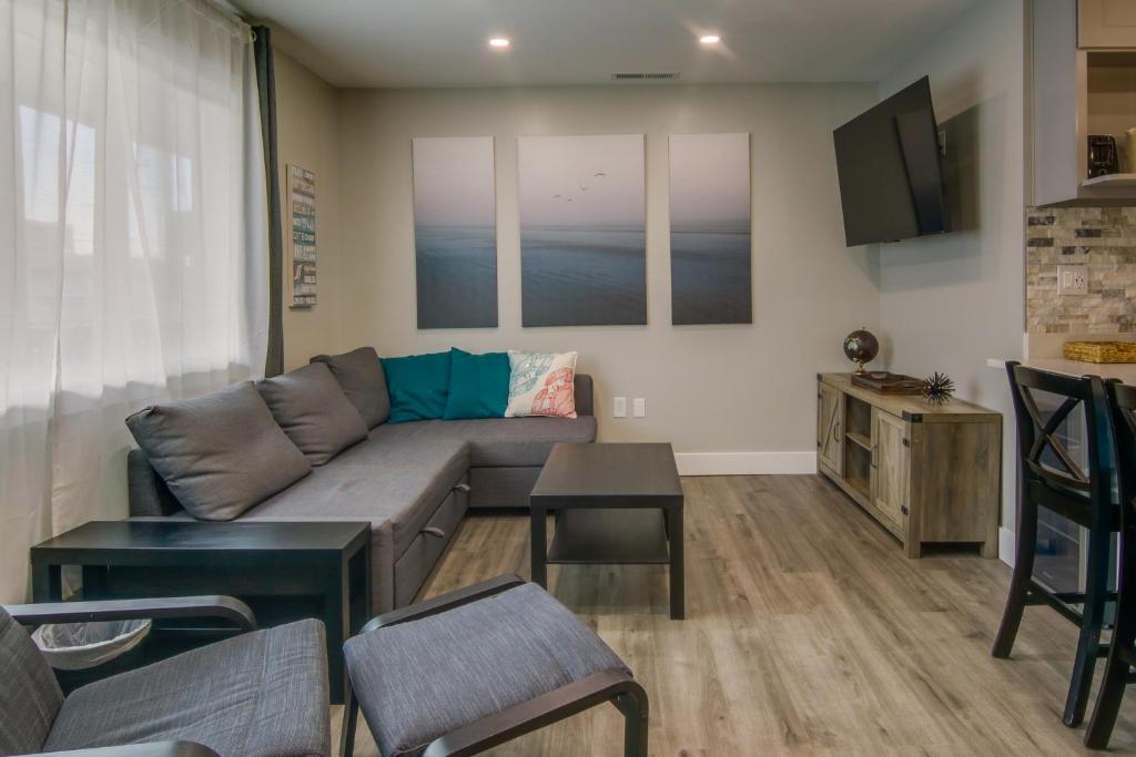 a living room with a couch and a tv at Walk to Beach and Boardwalk Ocean City Condo in Ocean City