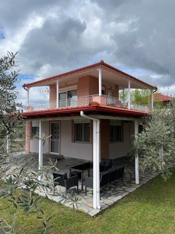 a house with a balcony on top of it at Seaside House in Karianí
