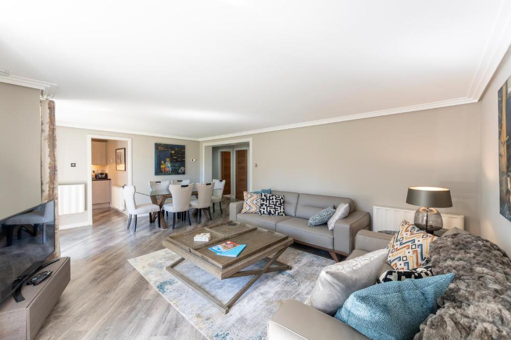 a living room with a couch and a table at Gleneagles Apartment - Guthrie Court Gleneagles in Auchterarder