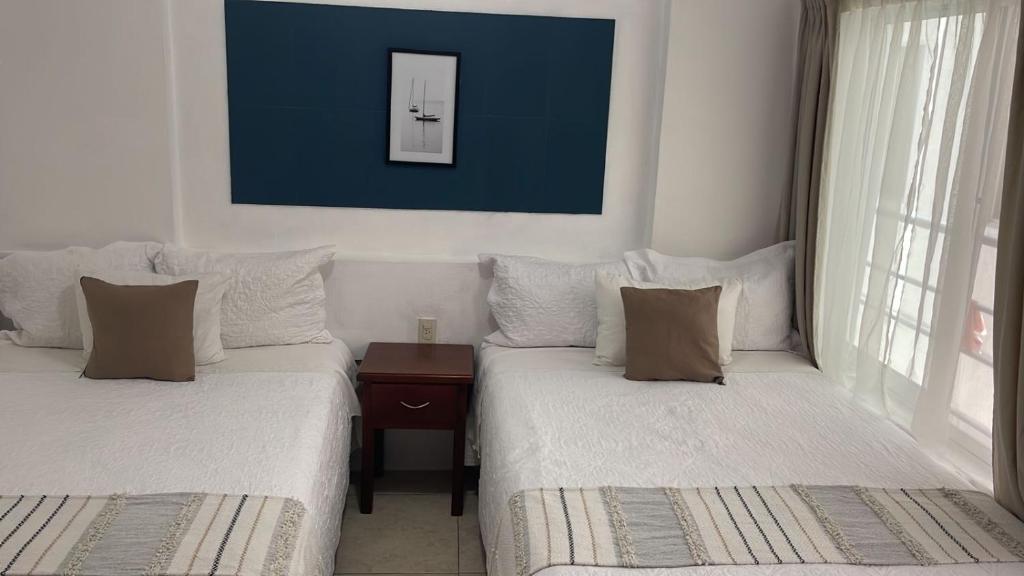 Postel nebo postele na pokoji v ubytování Hotel Real Villa