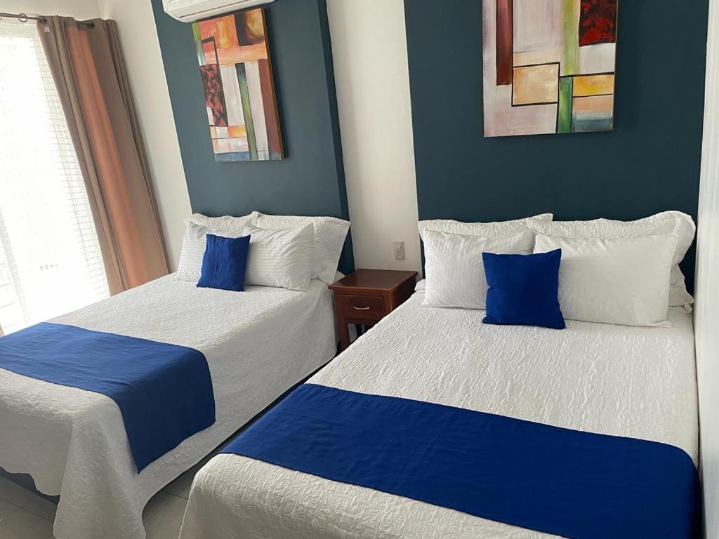 Postel nebo postele na pokoji v ubytování Hotel Real Villa