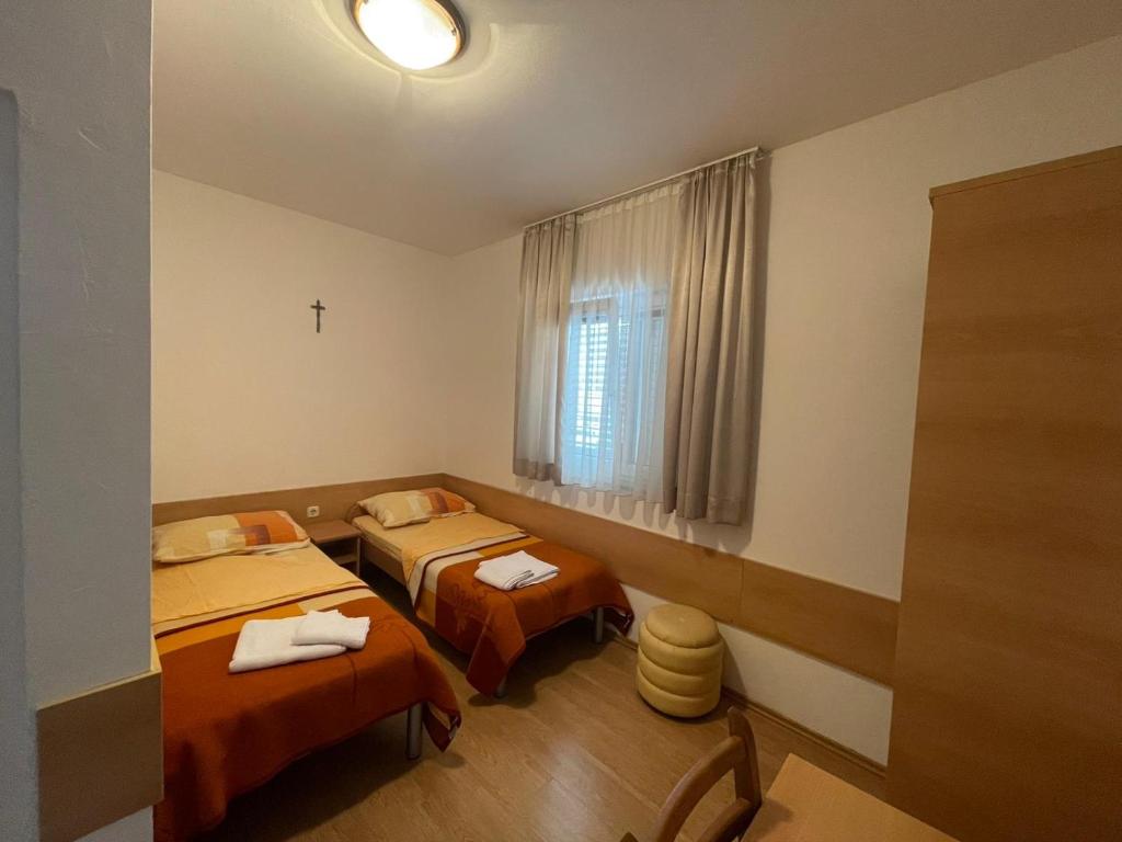 a room with two beds and a window at Maća i Ante Pavlović in Međugorje