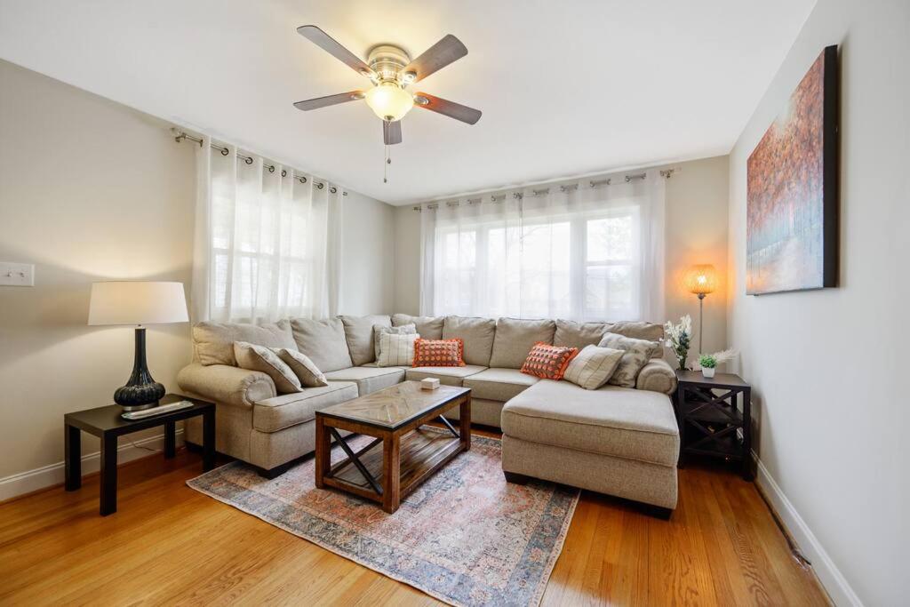 a living room with a couch and a ceiling fan at Charming DT 3-Bed Bungalow with Fenced-in Yard in Raleigh
