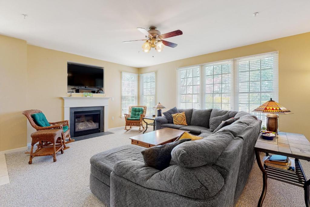 a living room with a couch and a fireplace at Bear Trap Dunes - 58A October Glory Ave in Ocean View