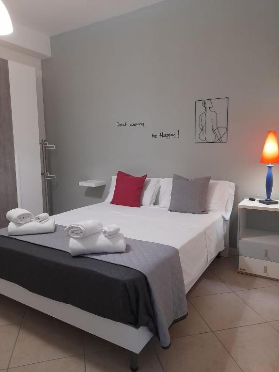 a bedroom with a large bed with towels on it at Il Girasole in Caserta