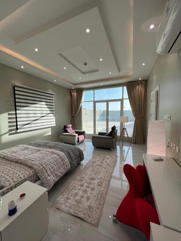 a bedroom with a large bed and a large window at شقة حديثة حي النرجس تسجيل ذاتي in Riyadh