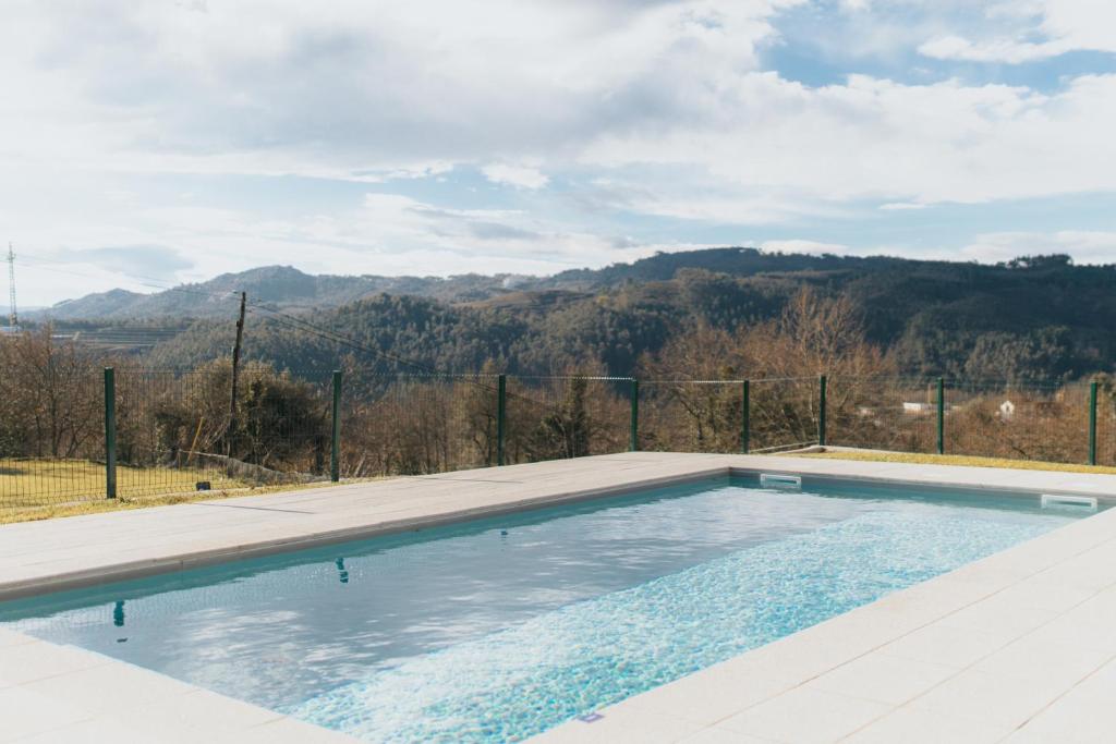a swimming pool with a view of the mountains at Quinta do Rabelo in Braga