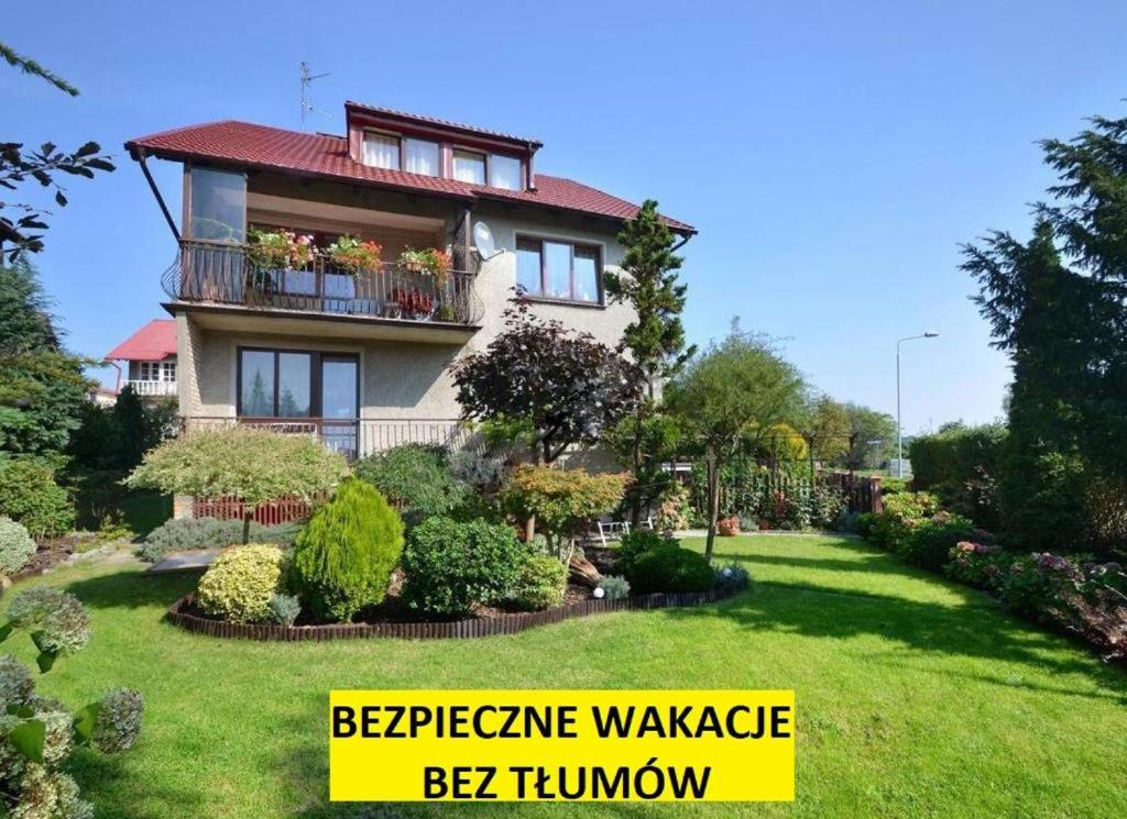 a house with a sign that reads experience warranty bebek thumb at Willa Szmaragd in Kołobrzeg