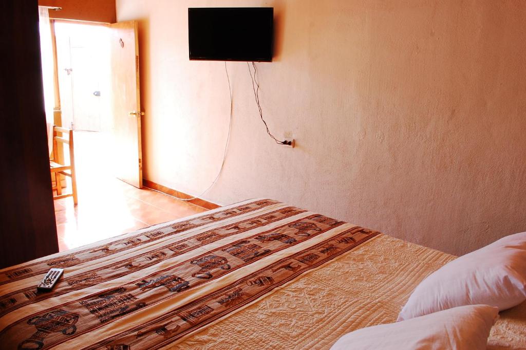 Postel nebo postele na pokoji v ubytování Hostal Pablito