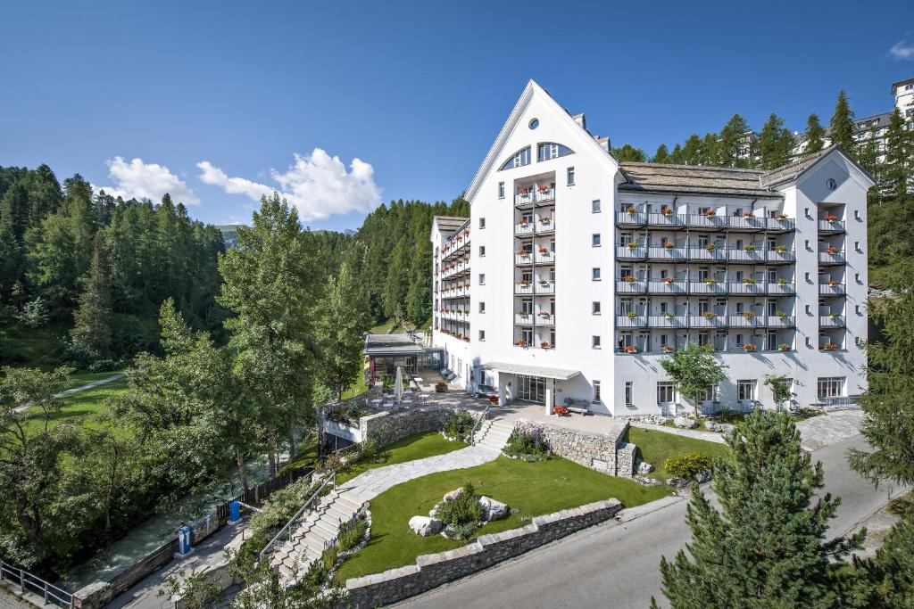 an aerial view of a hotel in the mountains at Arenas Resort Schweizerhof in Sils Maria