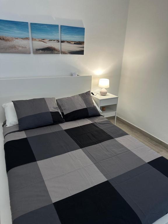 a bedroom with a black and white checkered bed at Dreams vacation tenerife in San Miguel de Abona