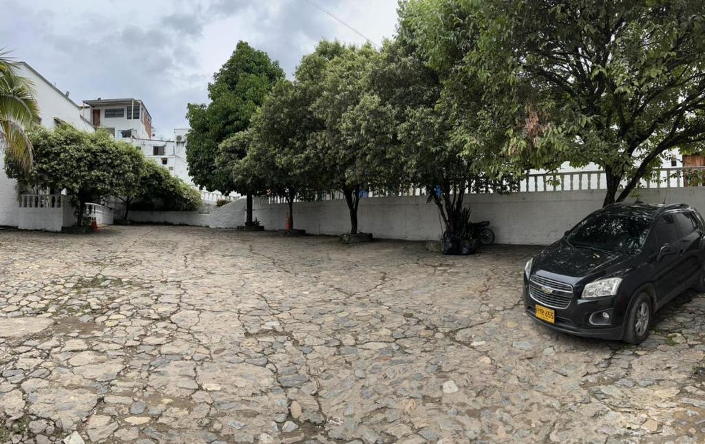 a car parked on a stone ground next to trees at Cabaña 41, aldea Doradal Santorini Colombiano in Puerto Triunfo