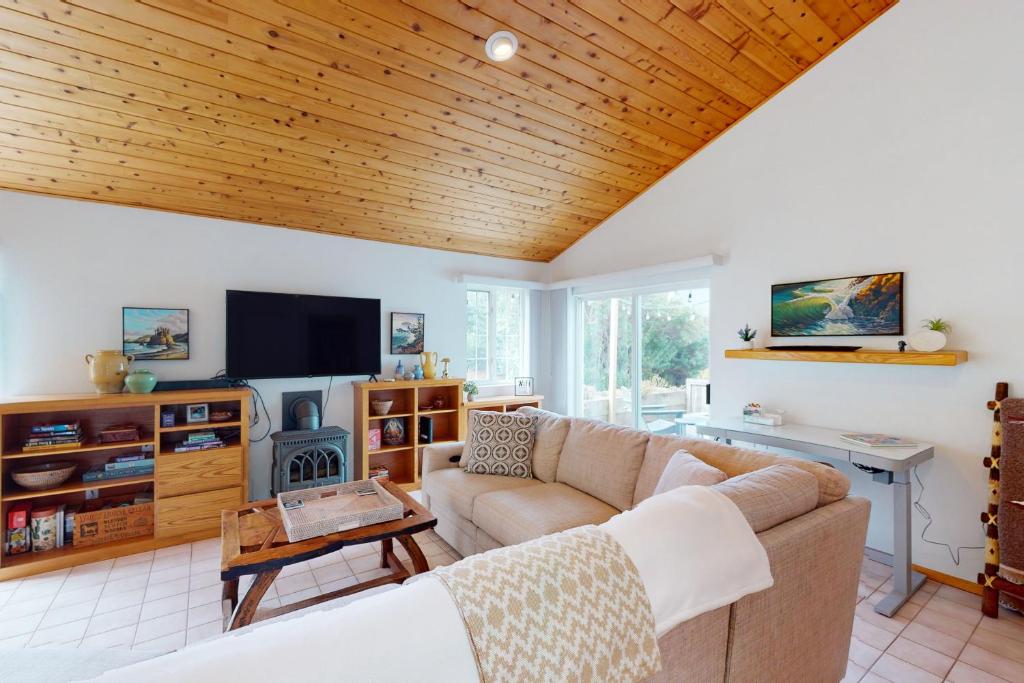 a living room with a couch and a tv at Good Fortune in McKinleyville