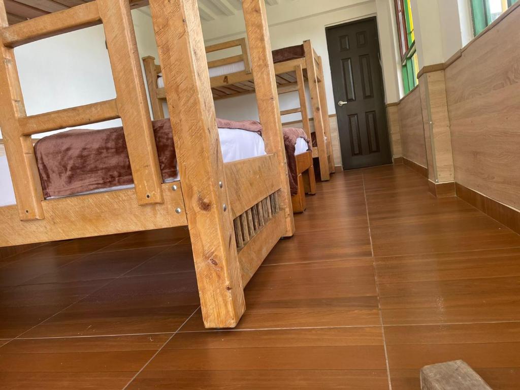 a hallway with two bunk beds in a room at Hostal Casa de Los Taitas in Salento