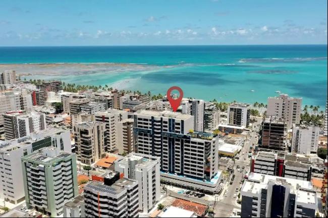 an aerial view of a city with a red sign at Edf Time Ponta Verde, Studio 523 in Maceió