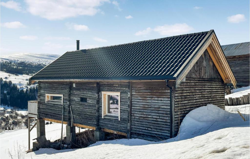 a wooden cabin in the snow in the snow at Awesome Home In len With Wifi And 2 Bedrooms in Ålen
