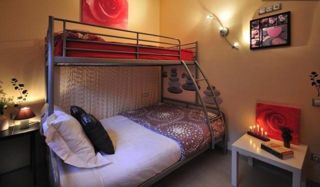 a bedroom with a bunk bed and a desk with a table at Vivalidays Abril in Blanes