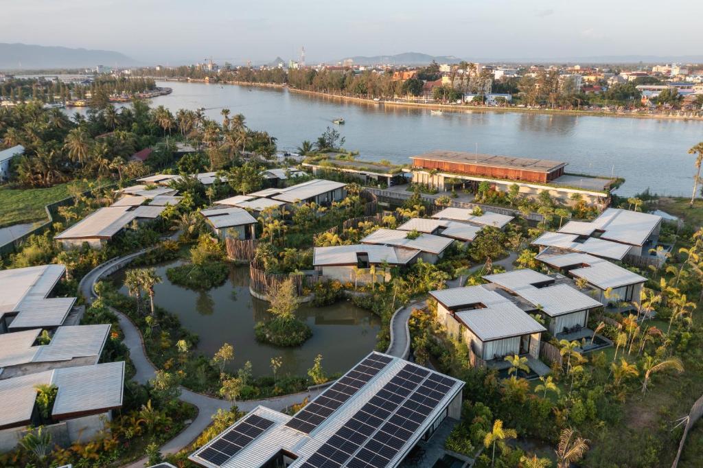 an aerial view of a solar farm next to a river at Amber Kampot in Kampot