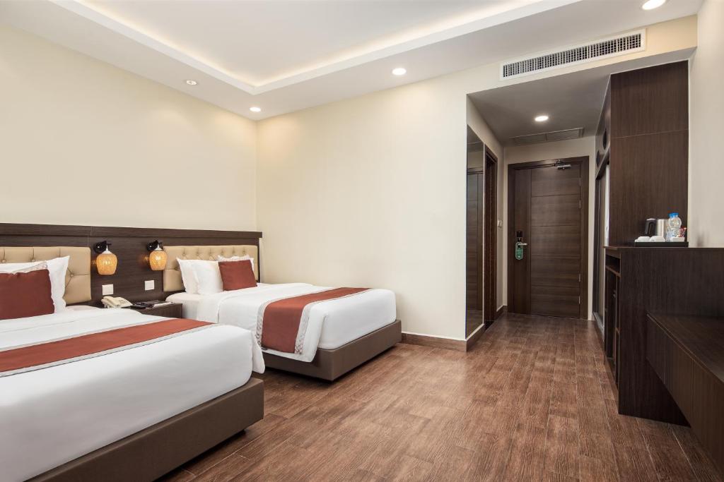 Postel nebo postele na pokoji v ubytování HM Grand Central Hotel
