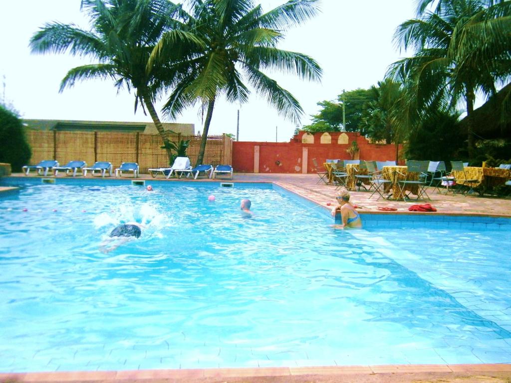 a group of people swimming in a swimming pool at Accra Royal Castle Apartments & Suites in Kwabenyan