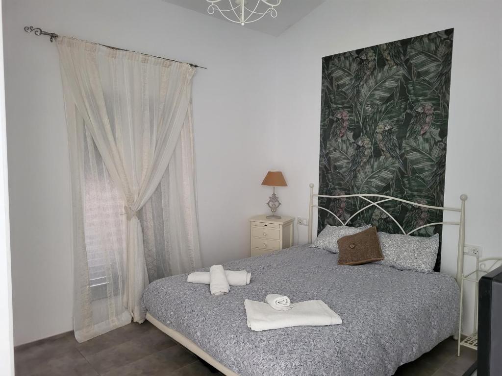 1 dormitorio con 1 cama con toallas en Lujo en Menorca, Ciutadella, piscina, padel, aparcamiento, en Sa Caleta