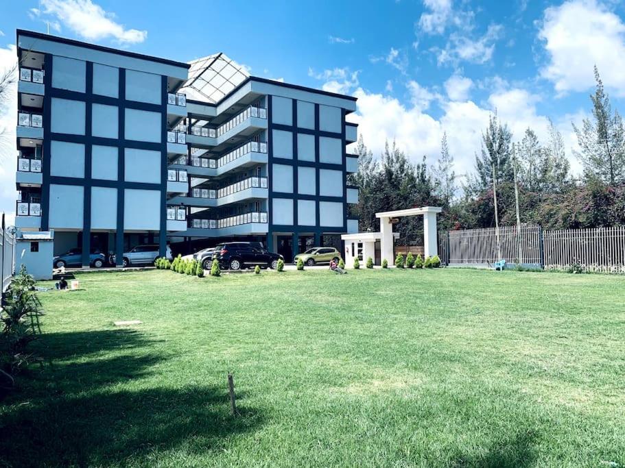 a large building with a large lawn in front of it at Arabel House Two Bedroom Nanyuki in Nanyuki
