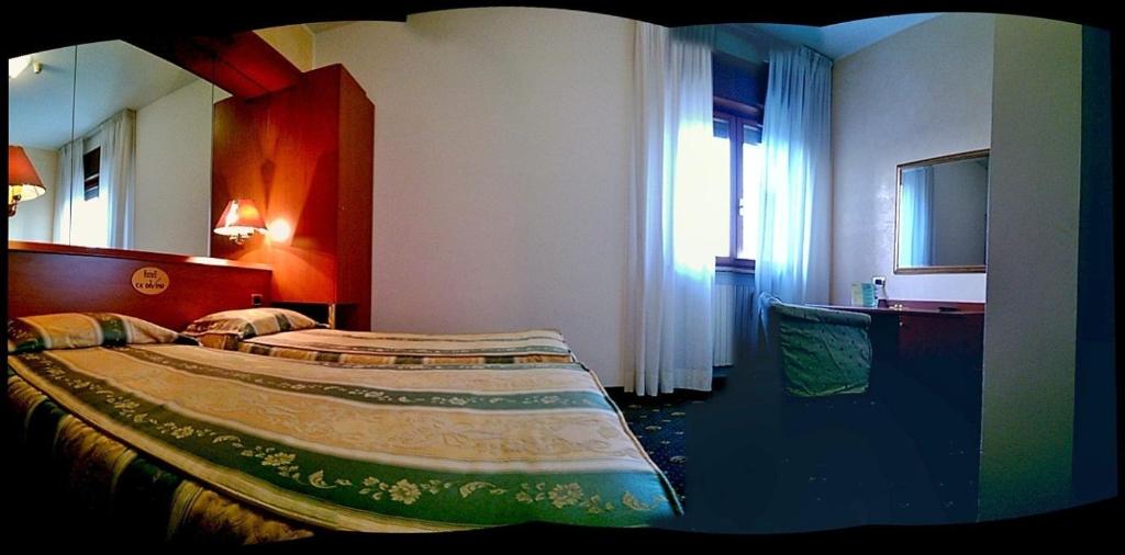 Postel nebo postele na pokoji v ubytování Hotel Green castellani