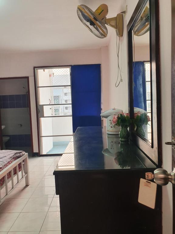 a kitchen with a black counter top and a mirror at Like Home in Chiang Mai