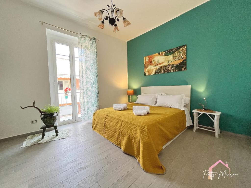 a bedroom with a bed and a green wall at Patty Maison - Large & New Central Apartment in Bari