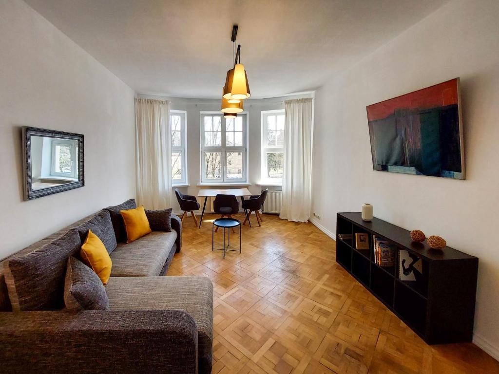 a living room with a couch and a table at Dainas 2-room Apartment - Arena Riga in Rīga