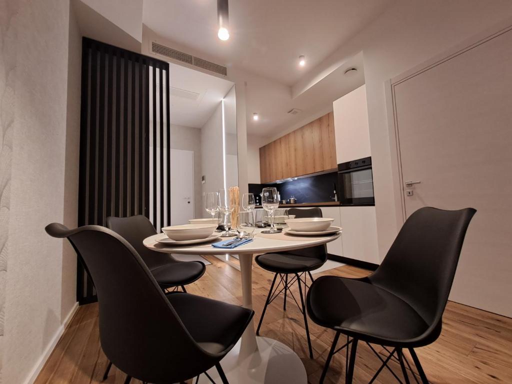 a dining room with a table and black chairs at Apartment Anya in Koper