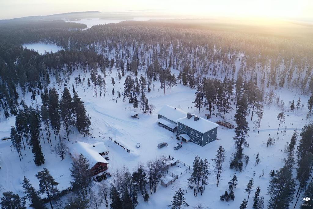 an aerial view of a building in the snow at Northernlight guesthouse in Kuusamo