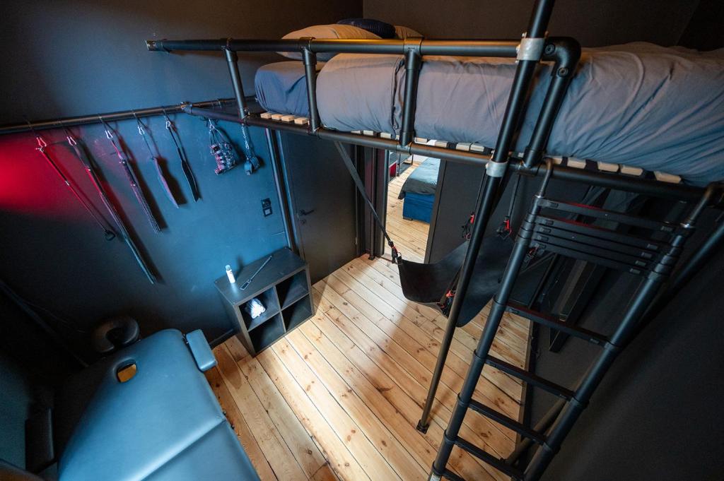 an overhead view of a dorm room with a bunk bed at The Rabbit Hole Antwerp - Romantic apartment with adult playroom in Antwerp