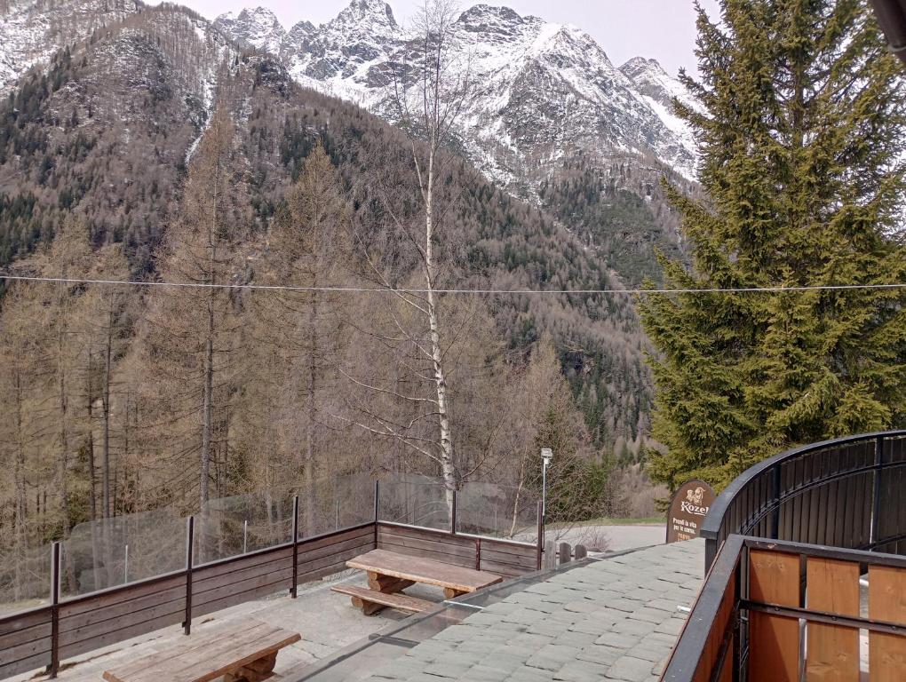 a picnic table on a balcony with a view of a mountain at Sasso Nero in Chiesa in Valmalenco