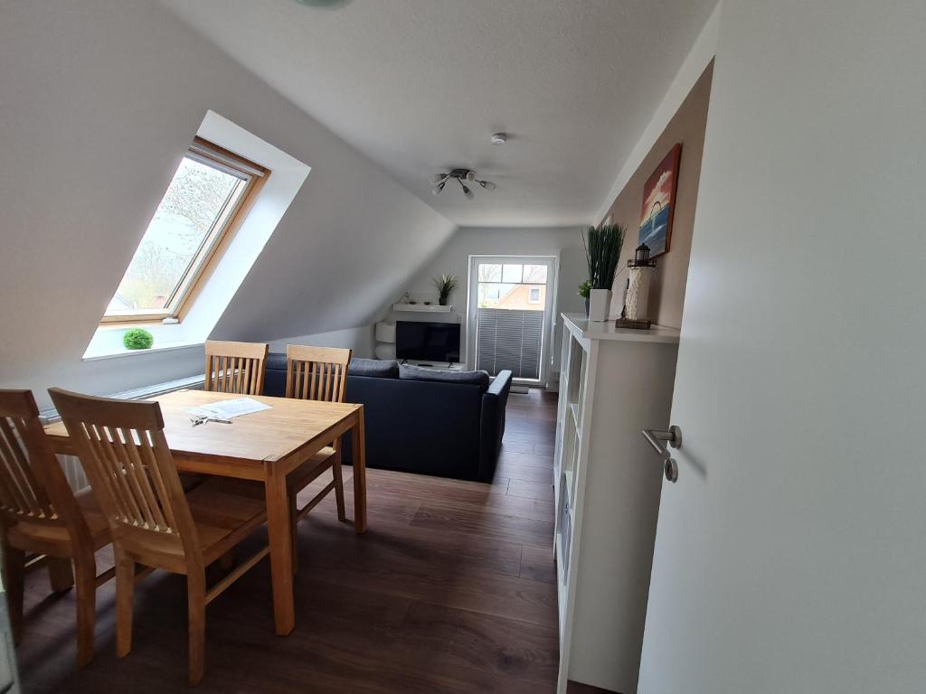 una cucina e una sala da pranzo con tavolo e sedie di Ferienwohnung Leuchtturmkieker in Schlagsdorf auf Fehmarn a Fehmarn