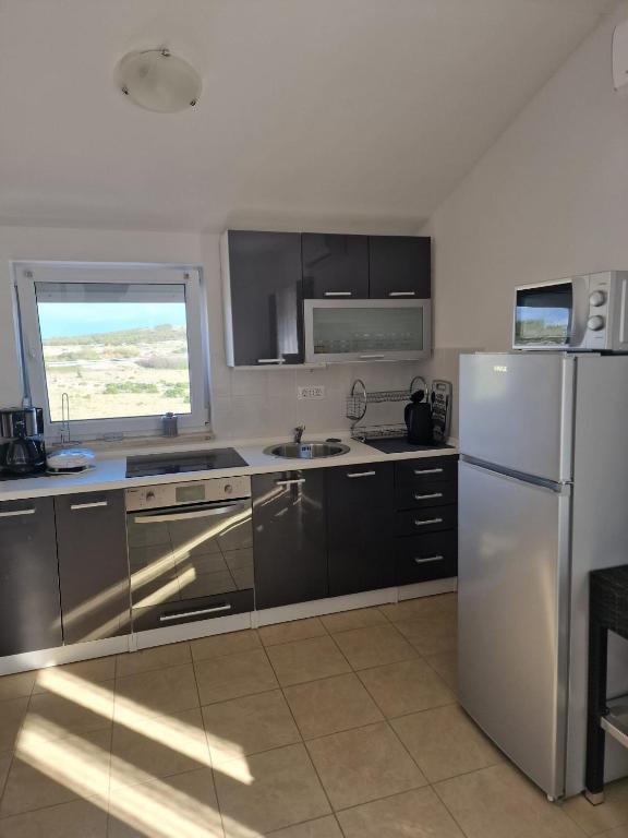 Kuchyň nebo kuchyňský kout v ubytování Apartmani Ivan