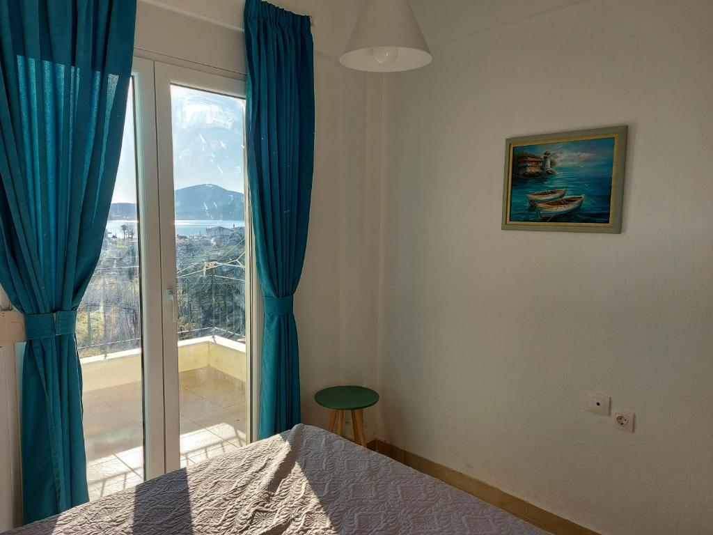 1 dormitorio con cama y ventana grande en Port bay view, Porto Coufo, en Porto Koufo