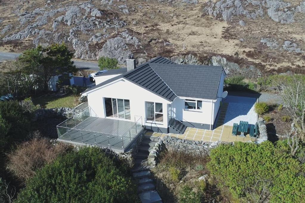 an overhead view of a white house with a roof at ' High Tor House, a taste of paradise on Harris ' in Tarbert