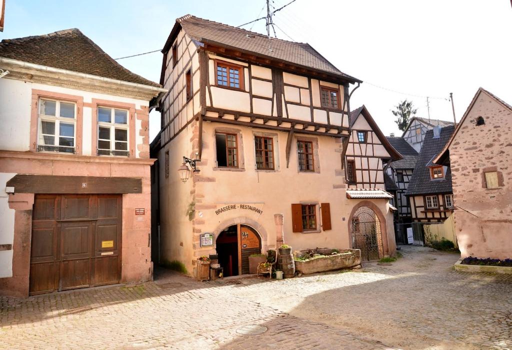 an old building in a medieval town with a street at My Riquewihr in Riquewihr