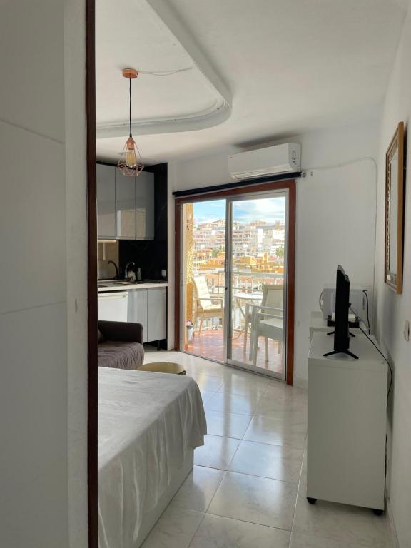 a bedroom with a bed and a view of a kitchen at Calle Manuel Mena 4 in Arroyo de la Miel