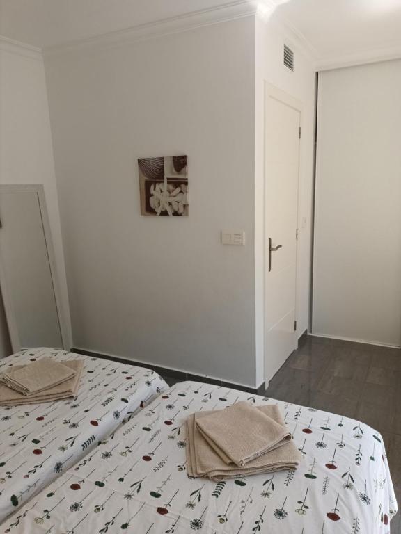A bed or beds in a room at Great oportunity Costa Adeje Holiday apartment first sea line Free Wifi