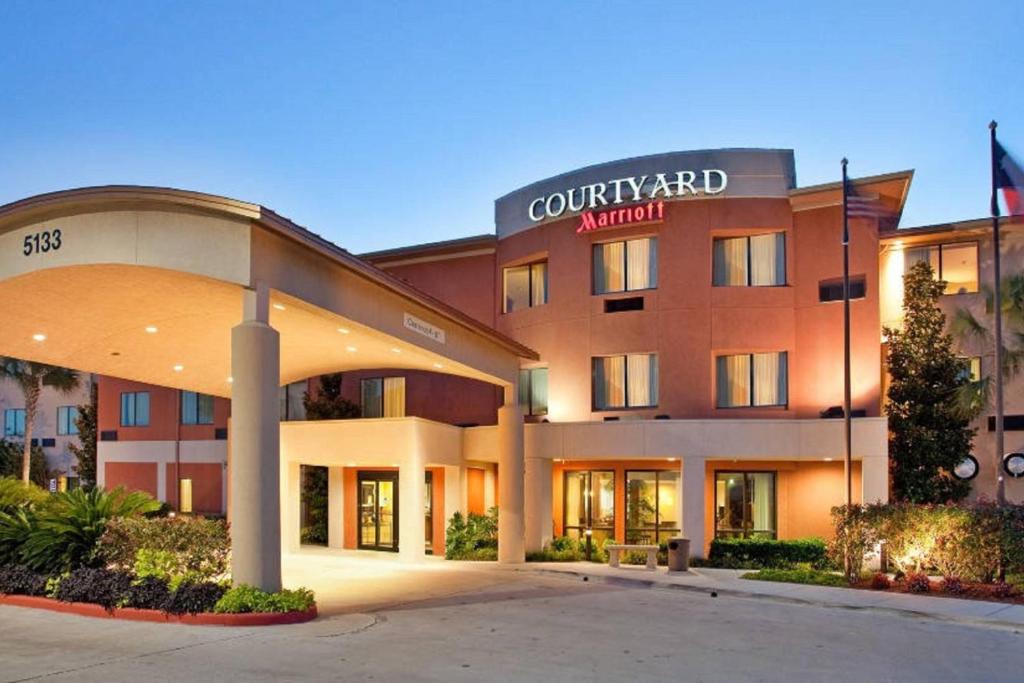 a hotel building with a sign on the front of it at Courtyard by Marriott Corpus Christi in Corpus Christi