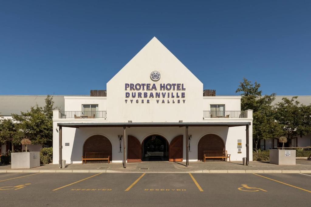 un edificio bianco con un cartello sul lato di Protea Hotel by Marriott Cape Town Durbanville a Bellville