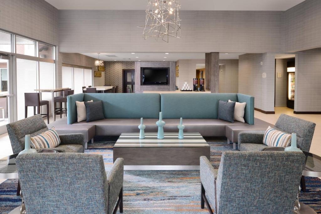 a living room with a couch and a table and chairs at Residence Inn by Marriott Dallas Plano The Colony in The Colony