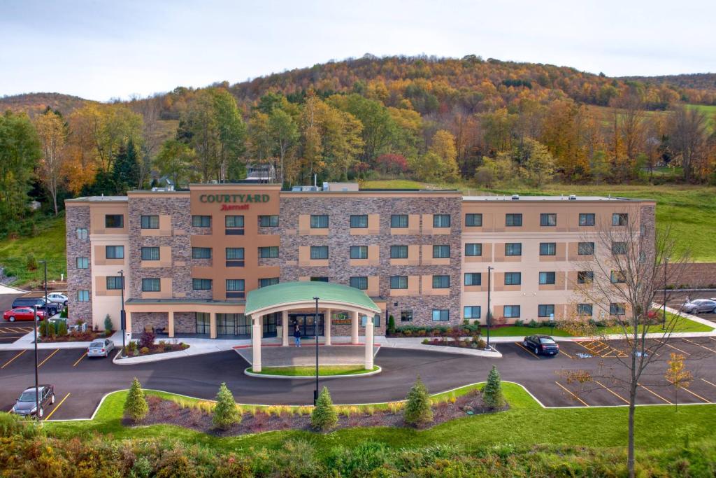 an image of a hotel with a gazebo in a parking lot at Courtyard by Marriott Oneonta in Oneonta