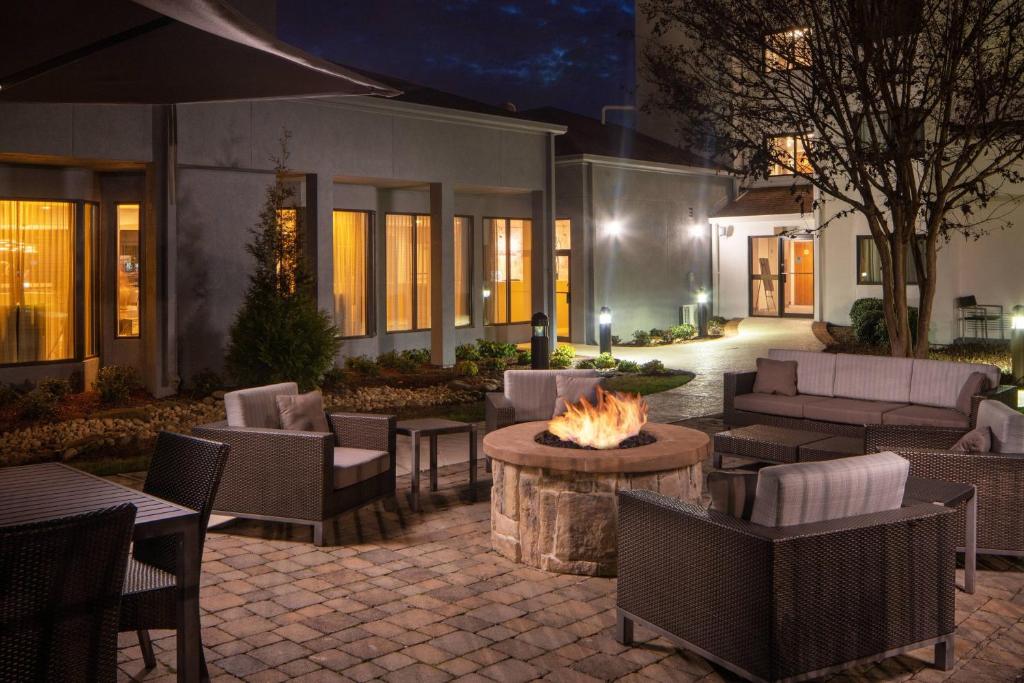 a patio with a fire pit and tables and chairs at Courtyard by Marriott Nashville Airport in Nashville